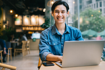 Asian man working at cafe on weekend