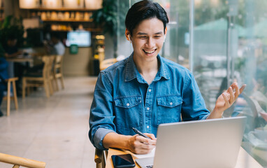 Asian man working at cafe on weekend