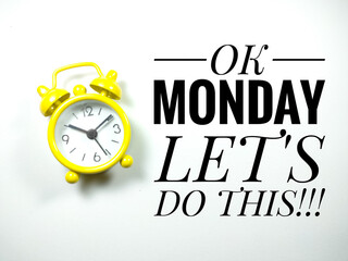 Word OK MONDAY LET'S DO THIS with yellow clock on white background.Motivation quote.