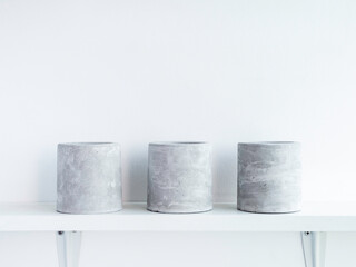 DIY concrete plant pot on white wall background