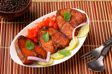 Fried fish, Kerala Fish fry in coconut oil India. Top view of fresh seafood curry served in house boat of Alappuzha. King or Barracuda fry. non vegetarian Indian food.	