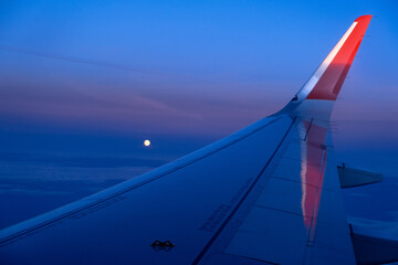 airplane window picture with sun on the horizon.