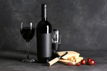Bottle and glass of wine on grunge background