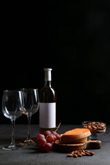 Composition with bottle of wine on dark background