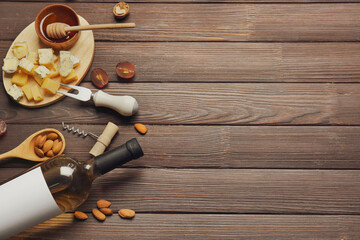 Composition with bottle of wine on wooden background