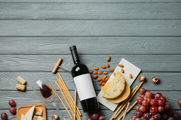 Composition with bottle of wine on wooden background