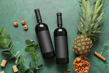 Composition with bottles of wine on color background