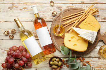 Composition with bottles of wine on white wooden background