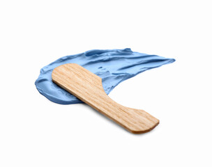 Sample of cosmetic clay and wooden spatula on white background