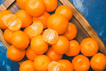 Tray with sweet tangerines on color background, closeup