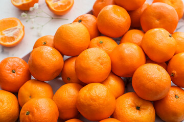 Many sweet tangerines on light background, closeup