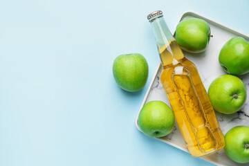 Composition with bottle of apple cider on color background