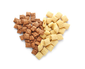 Heart made of tasty corn pillows on white background