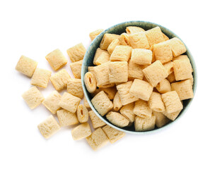 Bowl with tasty corn pillows on white background