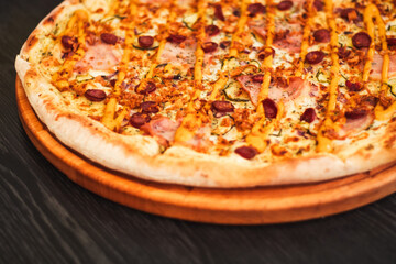 Bavarian pizza on round tray on wooden table
