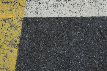 Fototapeta premium asphalt background with lines, white and yellow lines on a dark grey street, space for text, no person