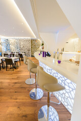 Modern bar counter with chairs and blurred background