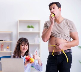 Doctor dietician giving advices to fat overweight patient