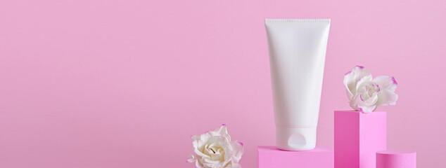 Banner with Beauty natural skincare product. Cream tube and flowers on different geometric podiums. Body Skincare products presentation