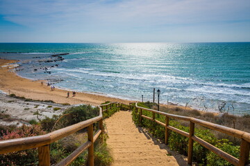 Staircase to the sandy beach of Agrigento, Sicily . Sandy beach, sunshine and turquoise sea  - obrazy, fototapety, plakaty