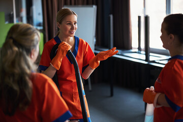 Female workers having a conversation during the office cleaning