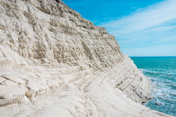 Perspective of a unique white rock formation by the blue green sea. Scala dei Turchi in Agrigento,...