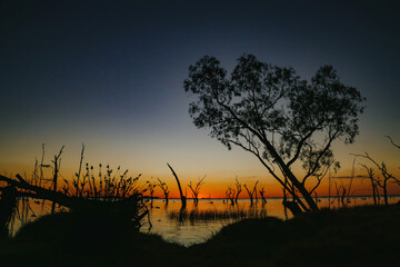 Vibrant orange sunset over the water at Kow Swamp, Victoria Australia