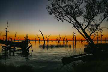 Vibrant orange sunset over the water at Kow Swamp, Victoria Australia