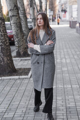 Fototapeta premium Portrait of an attractive girl on the street while walking