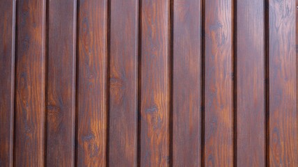 dark brown rustic background from planks of smoothly polished wood treated with stain, country-style backdrop surface in dark colors with a pronounced wood pattern