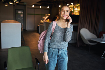 Joyous beautiful woman making a phone call