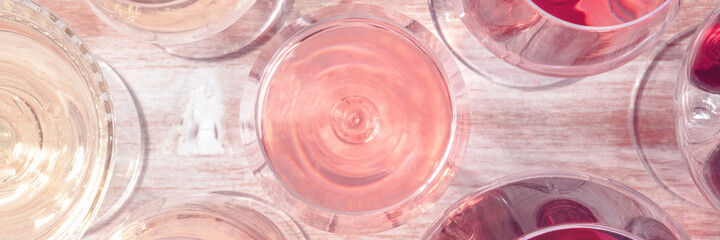 Toned wine panoramic background with a glass of rose