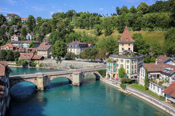 Fototapeta na wymiar Bern, Switzerland - August 18. 2013: Old town of Bern from the Mydegg Bridge over the Untertor bridge and the Aare river