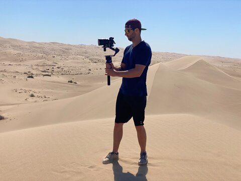 Filmmaker Shooting in the Desert Sand Dunes
