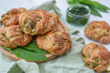 home made whole grain bread rolls with wild garlic on a table