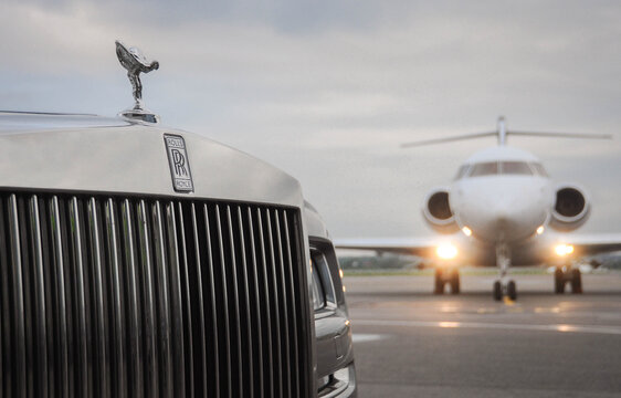 London, UK-7 MAY, 2019: Private executive airplane with limousine Rolls Royce Phantom luxury car shown together at international Heathrow Airport. VIP service at the airport. Business-class transfer.