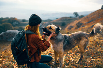 woman next to a dog outdoors vacation friendship