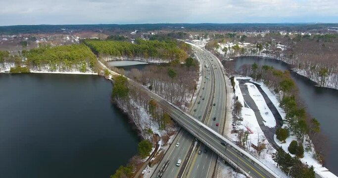 Aerial view of Lake Cochituate and Interstate Highway 90 in winter with snow in Cochituate State Park in town of Natick, Massachusetts MA, USA. 