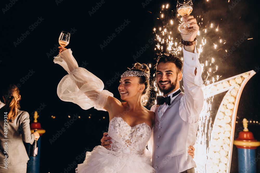 Wall mural Newlyweds are celebrating their wedding. Night fireworks. - Wall murals