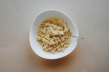 step by step preparation of the cake. Dough in a white plate.