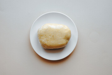 step by step preparation of the cake. Dough in a white plate.