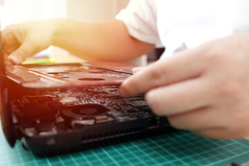 Close up of technician engineer trying to repairing broken laptop. Computer repairs and upgrade