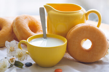 delicious donuts with cup of milk on the table