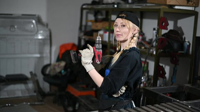 Video of a cute caucasian woman worker with a screwdriver at a production