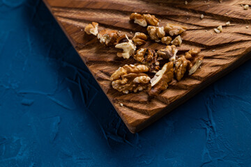 Walnut kernels on rustic board. Concept of healthy food and vegetarianism