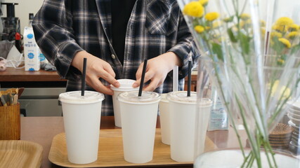 The hand of the man packing the take-out cup