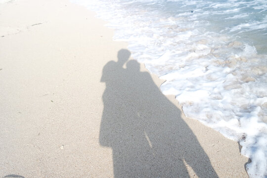 Silhouette of a couple on the beach at sunset