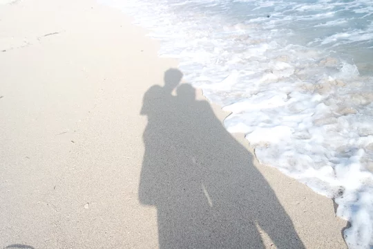 Silhouette of a couple on the beach at sunset