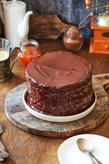Chocolate cake on a wooden table. Side view