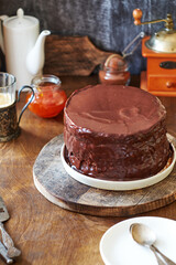 Fototapeta na wymiar Chocolate cake on a wooden table. Side view